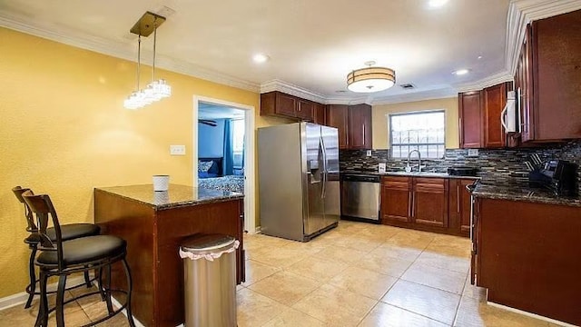 1831 N Miro St, New Orleans, LA 70119 - kitchen featuring stainless steel appliances, a sink, ornamental molding, and decorative backsplash