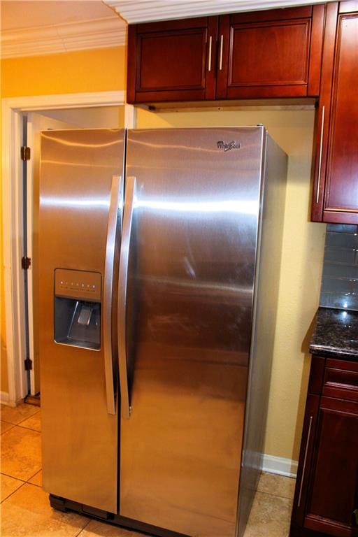 1831 N Miro St, New Orleans, LA 70119 - kitchen with light tile patterned floors, crown molding, dark brown cabinets, and stainless steel fridge