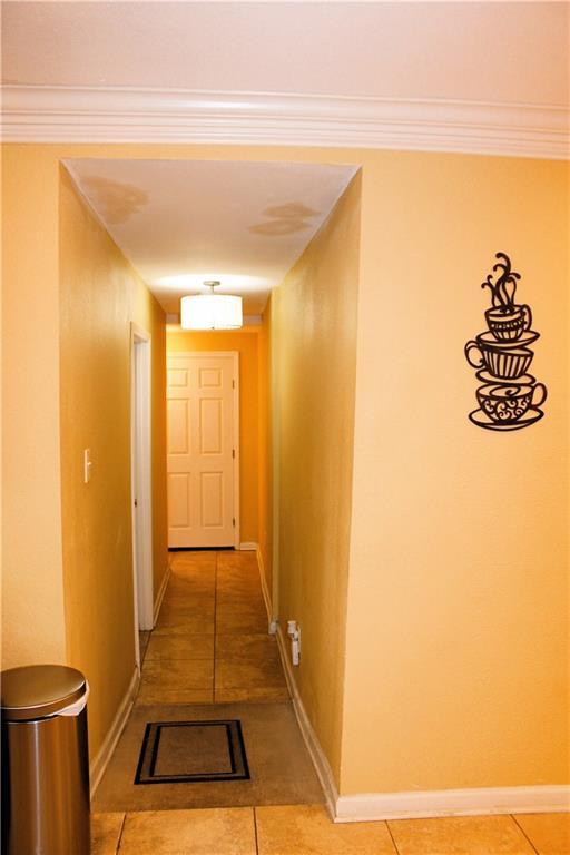 1831 N Miro St, New Orleans, LA 70119 - hall featuring baseboards, crown molding, and light tile patterned flooring