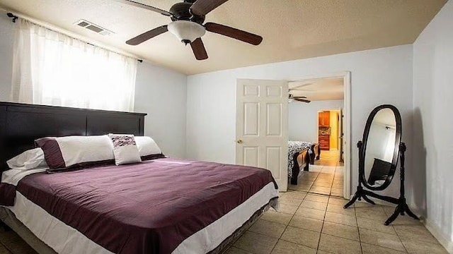 1831 N Miro St, New Orleans, LA 70119 - bedroom featuring a textured ceiling, light tile patterned floors, a ceiling fan, and visible vents