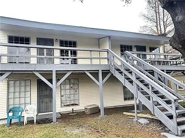 8002 Trapier Ave, New Orleans, LA 70127 - rear view of house featuring stairway and a wooden deck
