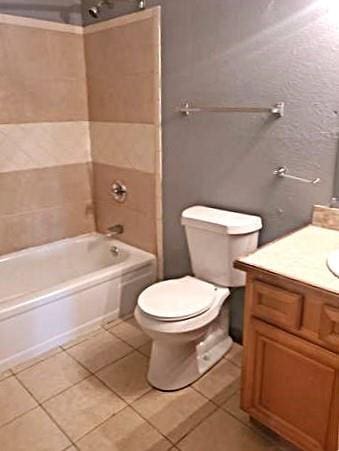 8002 Trapier Ave, New Orleans, LA 70127 - full bath featuring tile patterned floors, vanity, toilet, and  shower combination