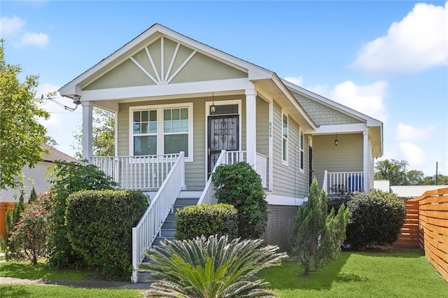6226 Lafaye St, New Orleans, LA 70122 - bungalow-style house featuring covered porch and a front lawn