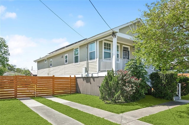 6226 Lafaye St, New Orleans, LA 70122 - view of side of property with a lawn, fence, and a porch