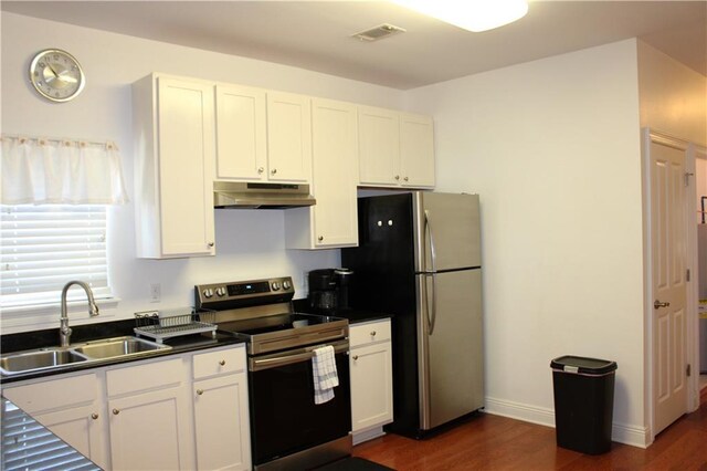6226 Lafaye St, New Orleans, LA 70122 - kitchen featuring dark wood-style flooring, a sink, stainless steel appliances, under cabinet range hood, and visible vents