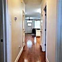 6226 Lafaye St, New Orleans, LA 70122 - corridor featuring baseboards and dark wood finished floors