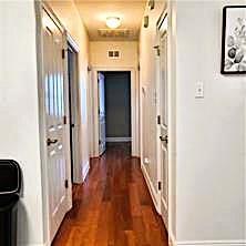 6226 Lafaye St, New Orleans, LA 70122 - corridor featuring baseboards and dark wood finished floors
