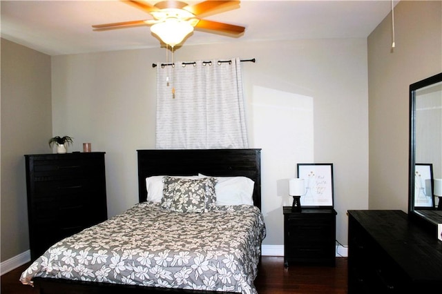 bedroom with ceiling fan and dark hardwood / wood-style floors