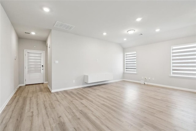 spare room featuring recessed lighting, visible vents, light wood finished floors, and baseboards