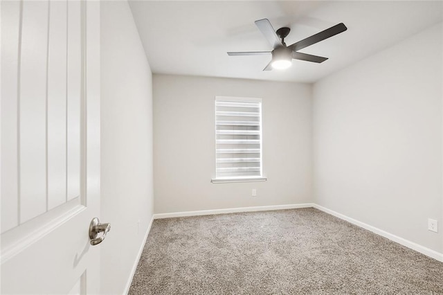 carpeted empty room with baseboards and a ceiling fan