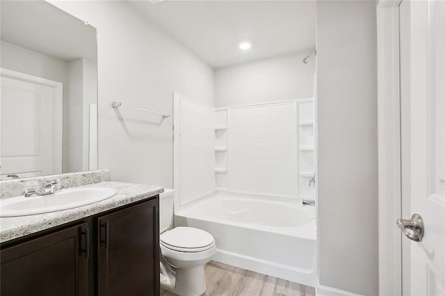 full bathroom with vanity, toilet, wood finished floors, and bathtub / shower combination