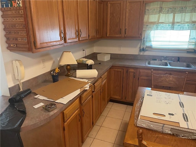 kitchen featuring sink and light tile patterned floors