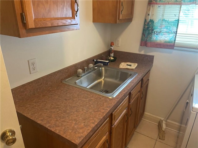 kitchen with light tile patterned floors and sink