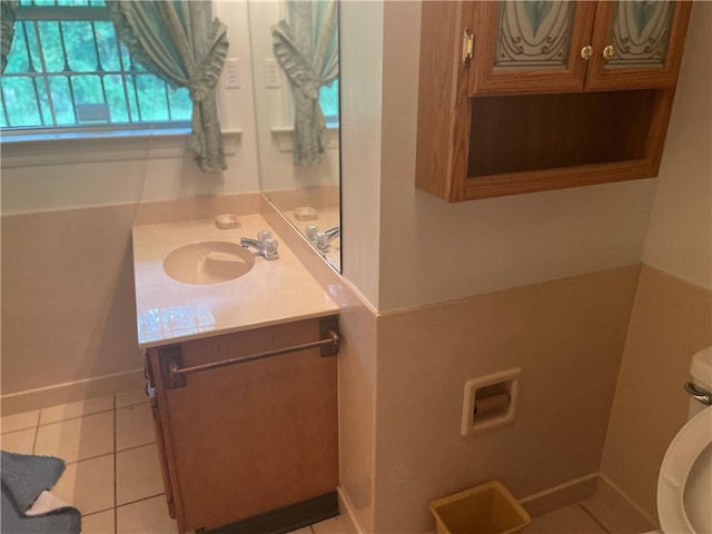 bathroom featuring tile patterned flooring, toilet, and vanity