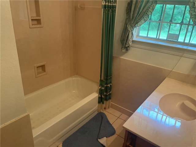 bathroom with tile patterned flooring, shower / bath combo with shower curtain, and vanity