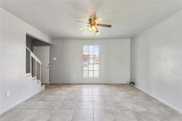 3 Shepard Ct, New Orleans, LA 70114 - empty room featuring stairs, baseboards, ceiling fan, a textured ceiling, and light tile patterned floors