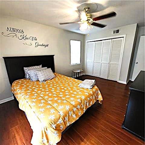 bedroom with a closet, ceiling fan, and dark hardwood / wood-style flooring