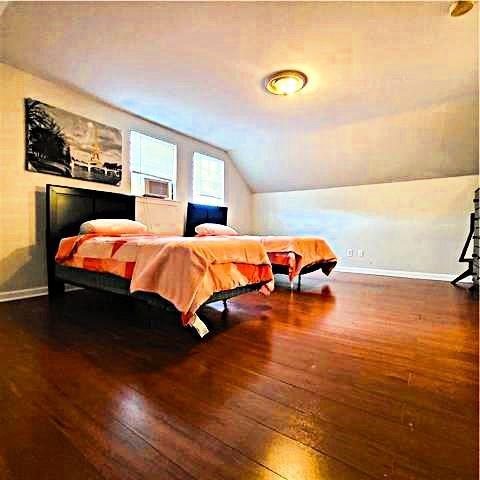 bedroom featuring dark hardwood / wood-style floors and vaulted ceiling