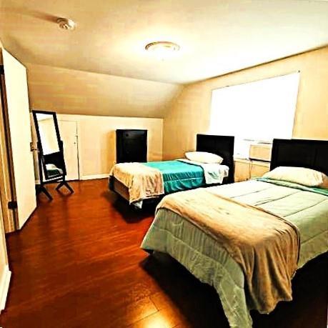 bedroom with lofted ceiling and dark hardwood / wood-style floors