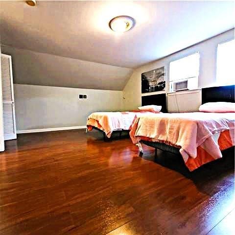 3738 Somerset Dr, New Orleans, LA 70131 - bedroom with baseboards, wood finished floors, and lofted ceiling