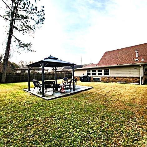 exterior space featuring a lawn, a patio, and a gazebo