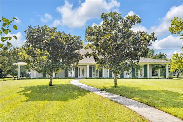 view of property hidden behind natural elements featuring a front yard