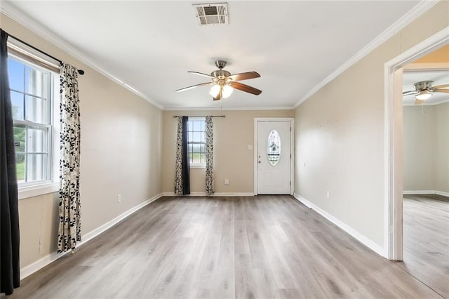 entryway with ceiling fan, ornamental molding, and wood-type flooring