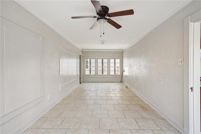 unfurnished room with ceiling fan, light tile patterned flooring, and ornamental molding