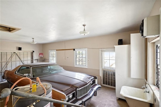 interior space with sink, concrete flooring, and a healthy amount of sunlight