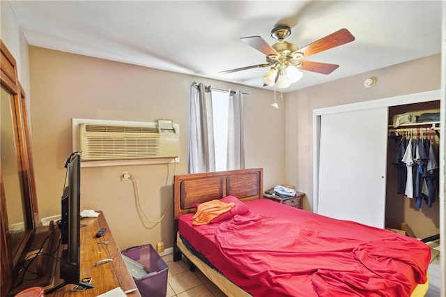 tiled bedroom with a closet, ceiling fan, and a wall mounted air conditioner