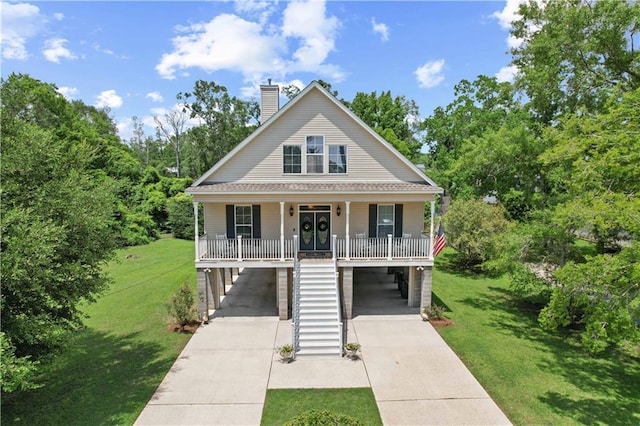 view of front of home with a front lawn, a porch, and a carport