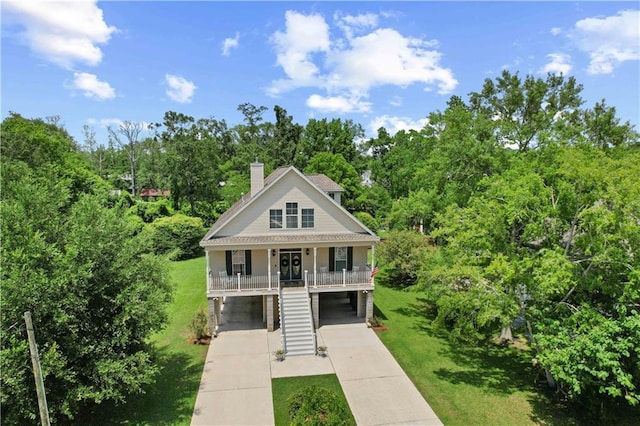 view of front of house featuring a front yard, a porch, and a carport