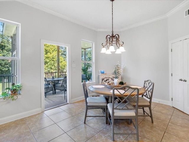 dining space with light tile patterned flooring, crown molding, and a chandelier