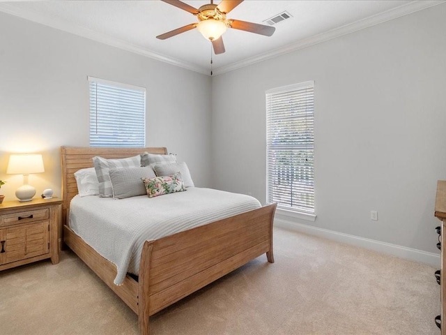 bedroom with ceiling fan, light colored carpet, and crown molding