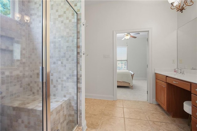 bathroom with vanity, a shower with door, and a wealth of natural light