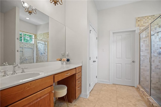 bathroom featuring vanity, a notable chandelier, a shower with door, and tile patterned floors