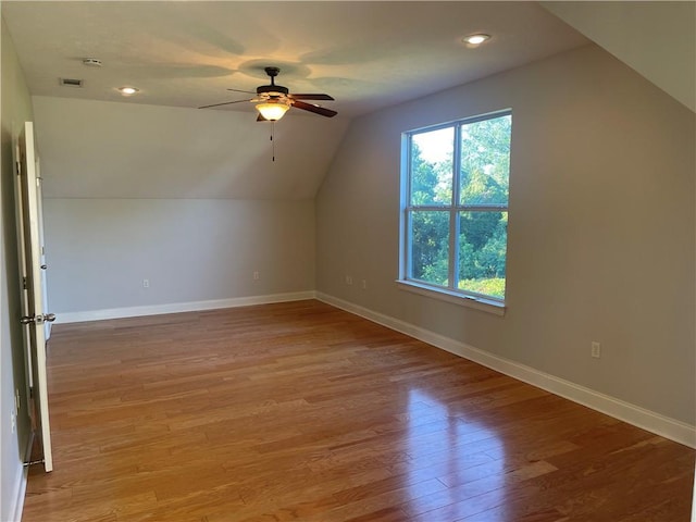 additional living space featuring light hardwood / wood-style floors, ceiling fan, and vaulted ceiling