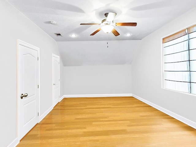 bonus room with ceiling fan, light hardwood / wood-style flooring, and lofted ceiling