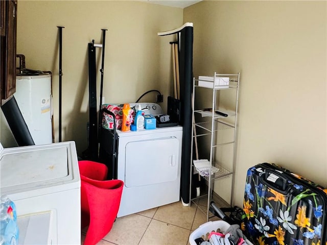 laundry room featuring water heater, light tile patterned floors, and separate washer and dryer