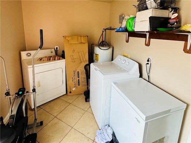 laundry room with independent washer and dryer, light tile patterned floors, and electric water heater