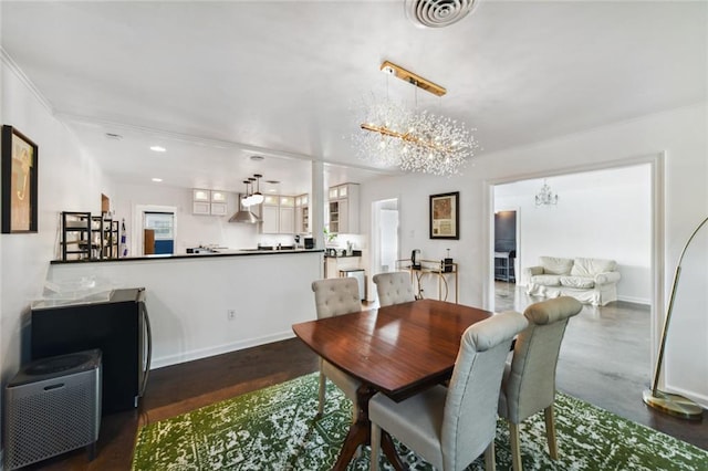 dining space featuring a notable chandelier and dark wood-type flooring