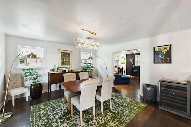 dining area featuring wine cooler and a chandelier