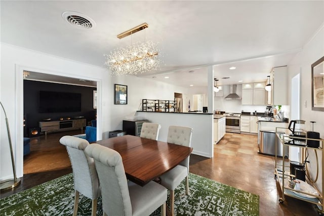 dining area with sink and a notable chandelier