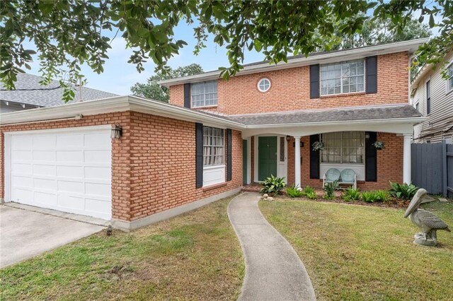 view of front of house featuring a garage and a lawn