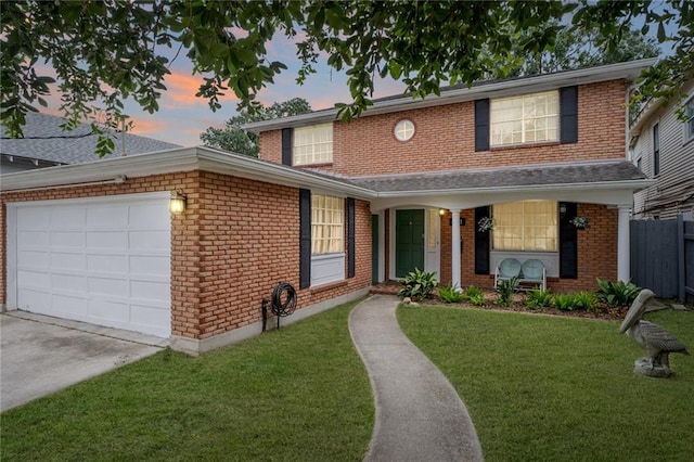 view of front of home with a garage and a lawn