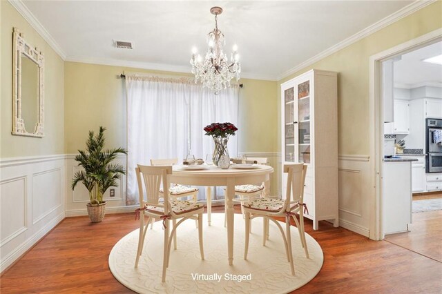 living room with ornamental molding and hardwood / wood-style floors