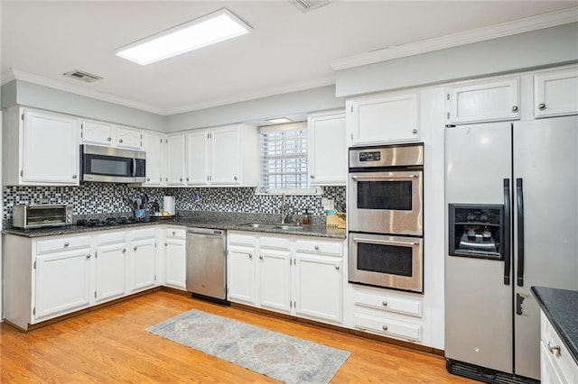 kitchen featuring sink, stainless steel appliances, and white cabinets