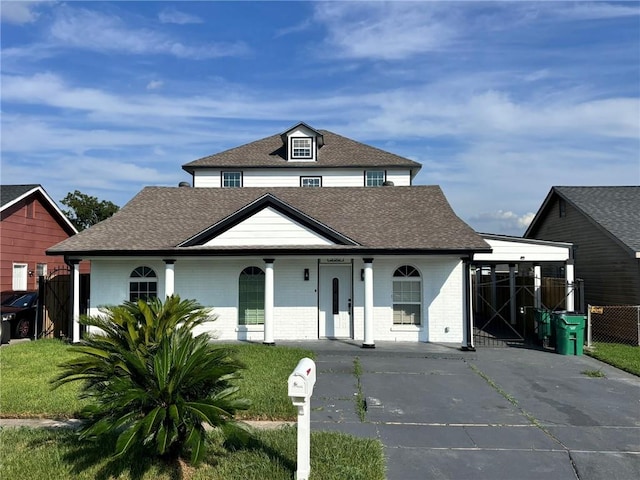 view of front of home with a porch and a carport