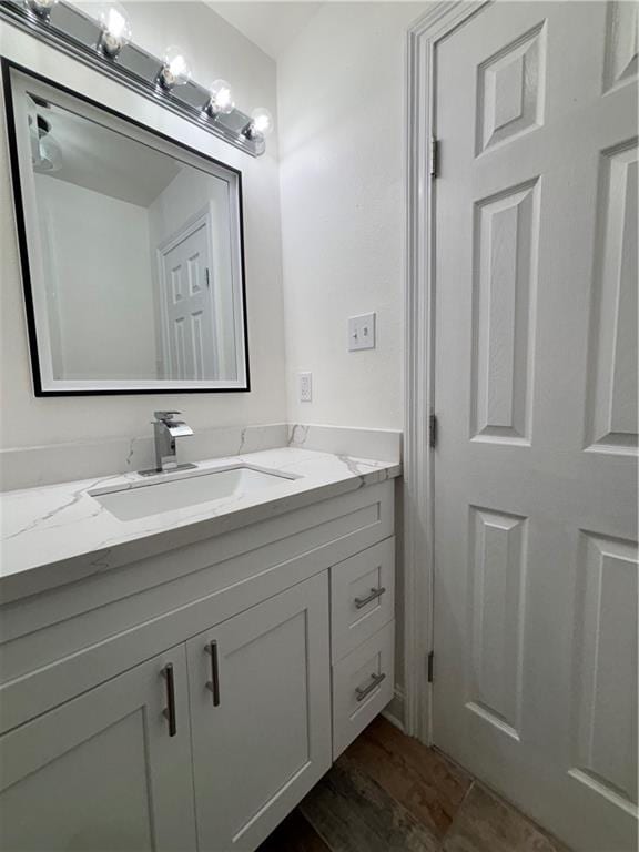 bathroom featuring vanity and wood finished floors