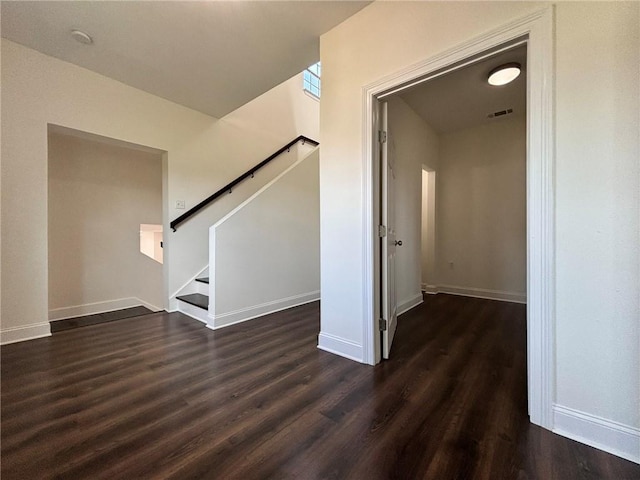 interior space featuring visible vents, baseboards, and wood finished floors